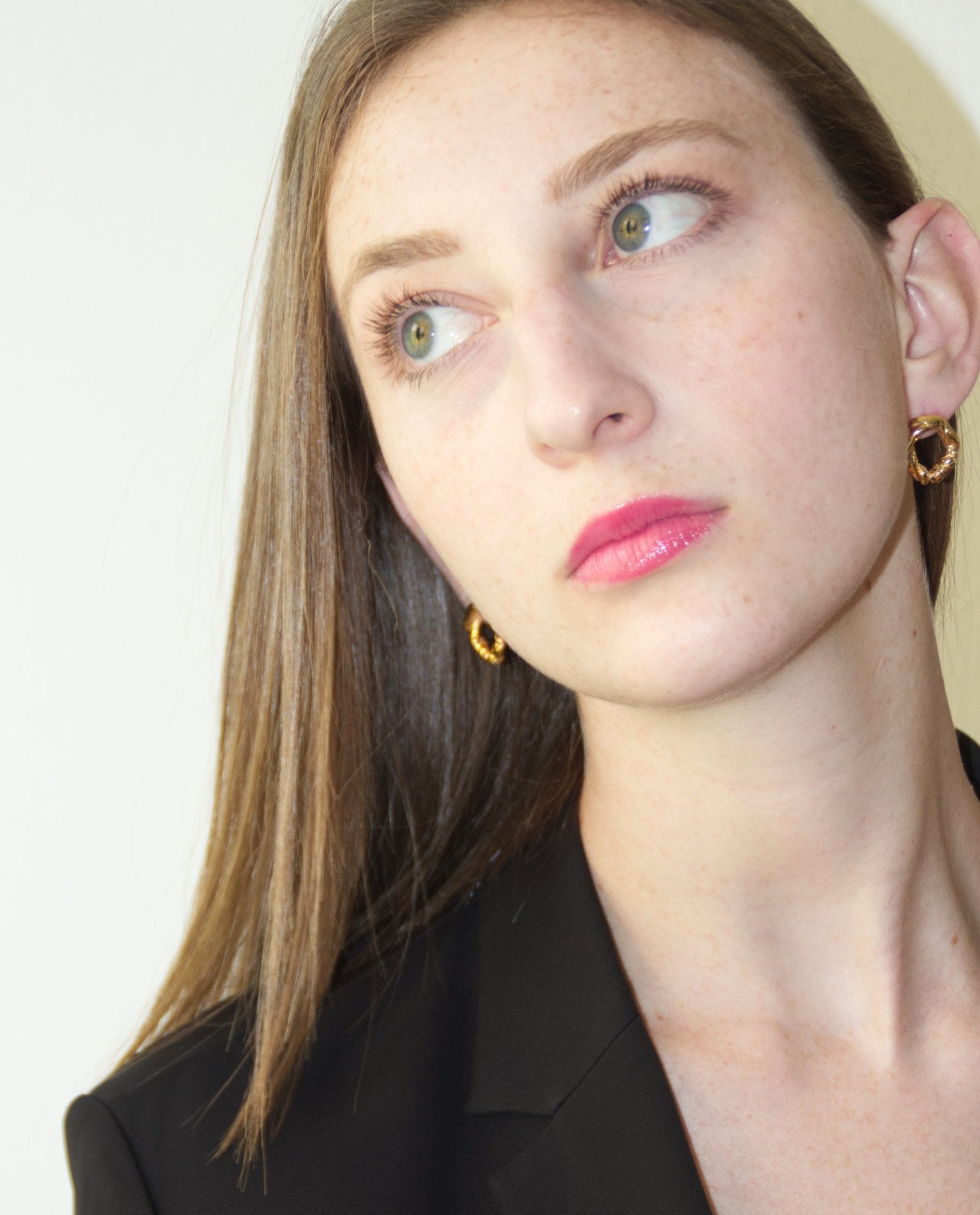 Gold minimalist modern twisted earrings. Made in Brooklyn New York by designer llayers.
