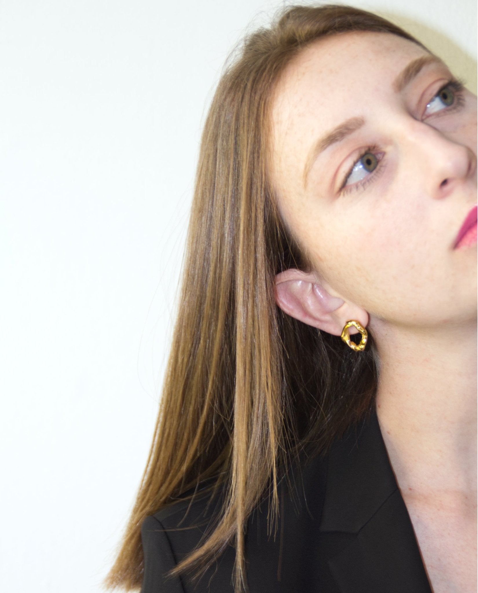 Gold minimalist modern twisted earrings. Made in Brooklyn New York by designer llayers.