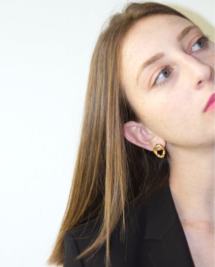 Gold minimalist modern twisted earrings. Made in Brooklyn New York by designer llayers.