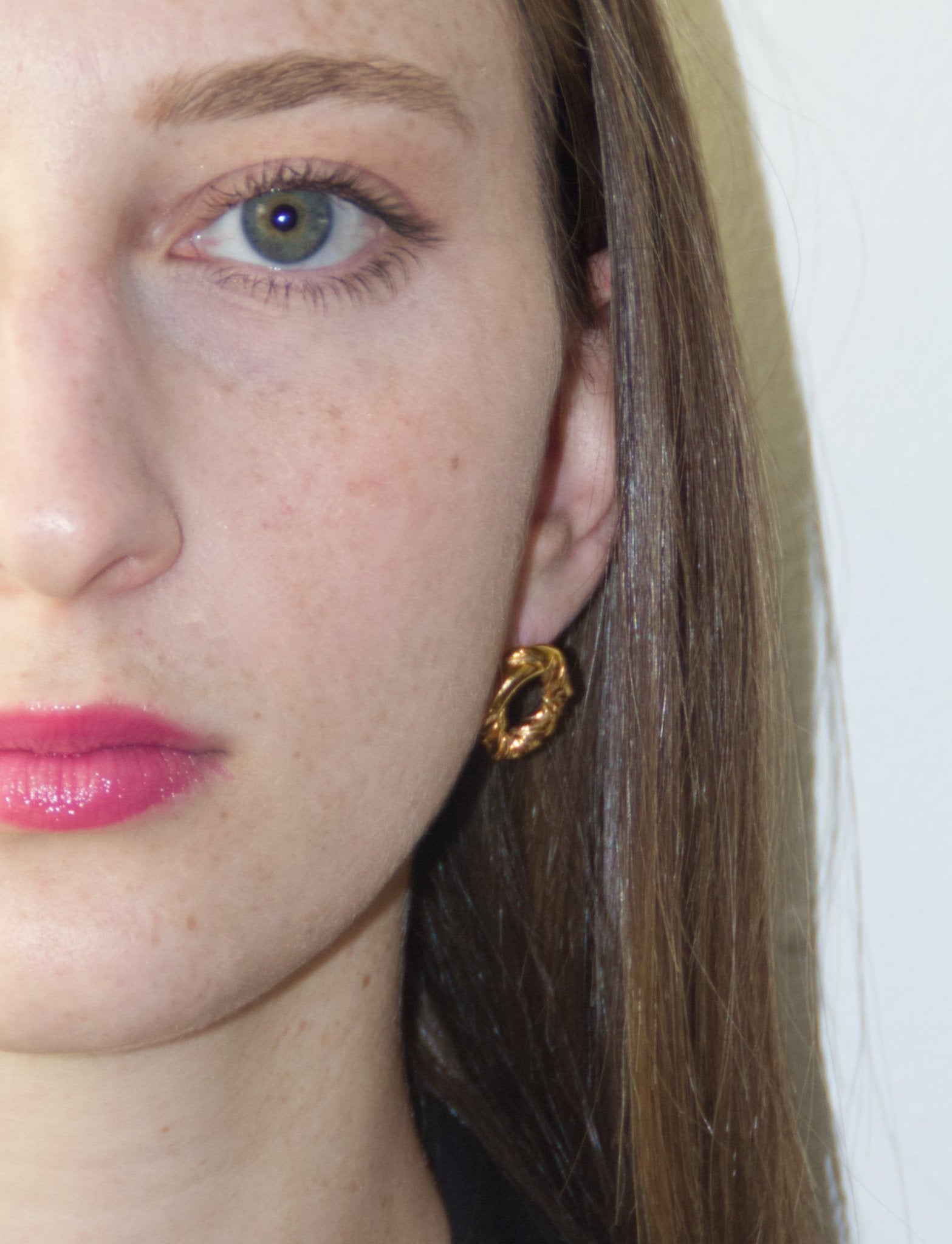 Women's gold minimalist modern twisted earrings. Made in Brooklyn New York by designer llayers.