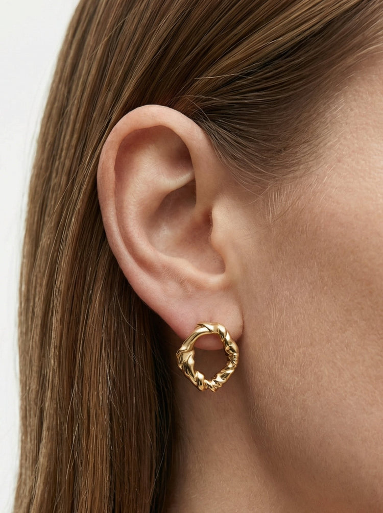 Gold minimalist modern twisted earrings. Made in Brooklyn New York by designer llayers.