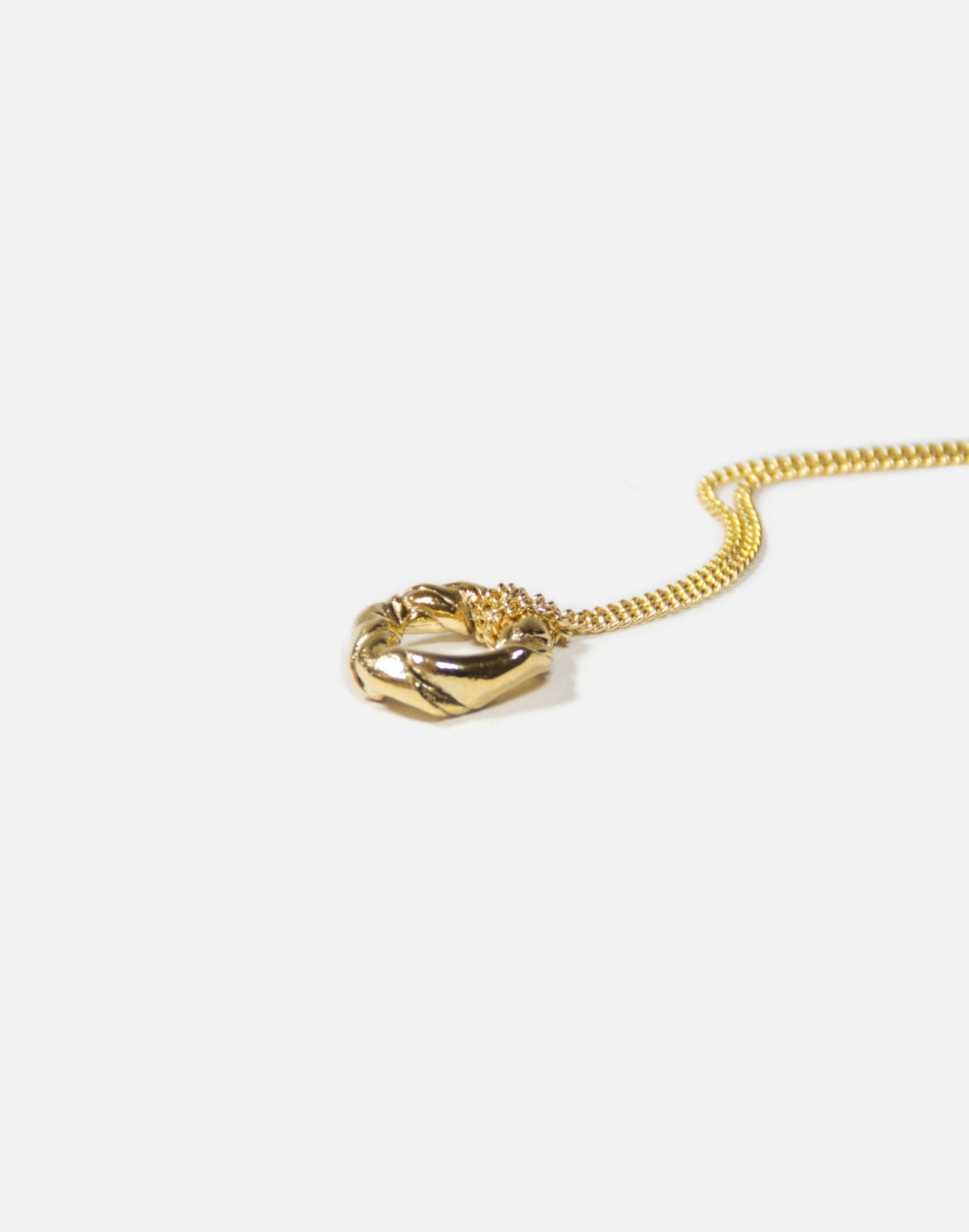 Gold minimalist pendant necklace. Twisted jewelry made in Brooklyn New York by designer llayers.