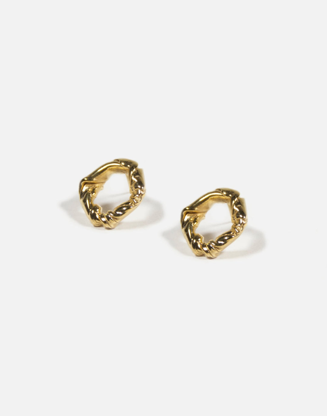 Gold minimalist modern twisted earrings. Made in Brooklyn New York by designer llayers.