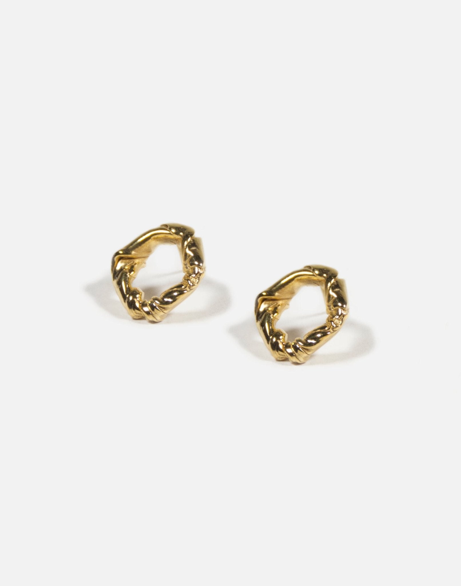 Gold minimalist modern twisted earrings. Made in Brooklyn New York by designer llayers.