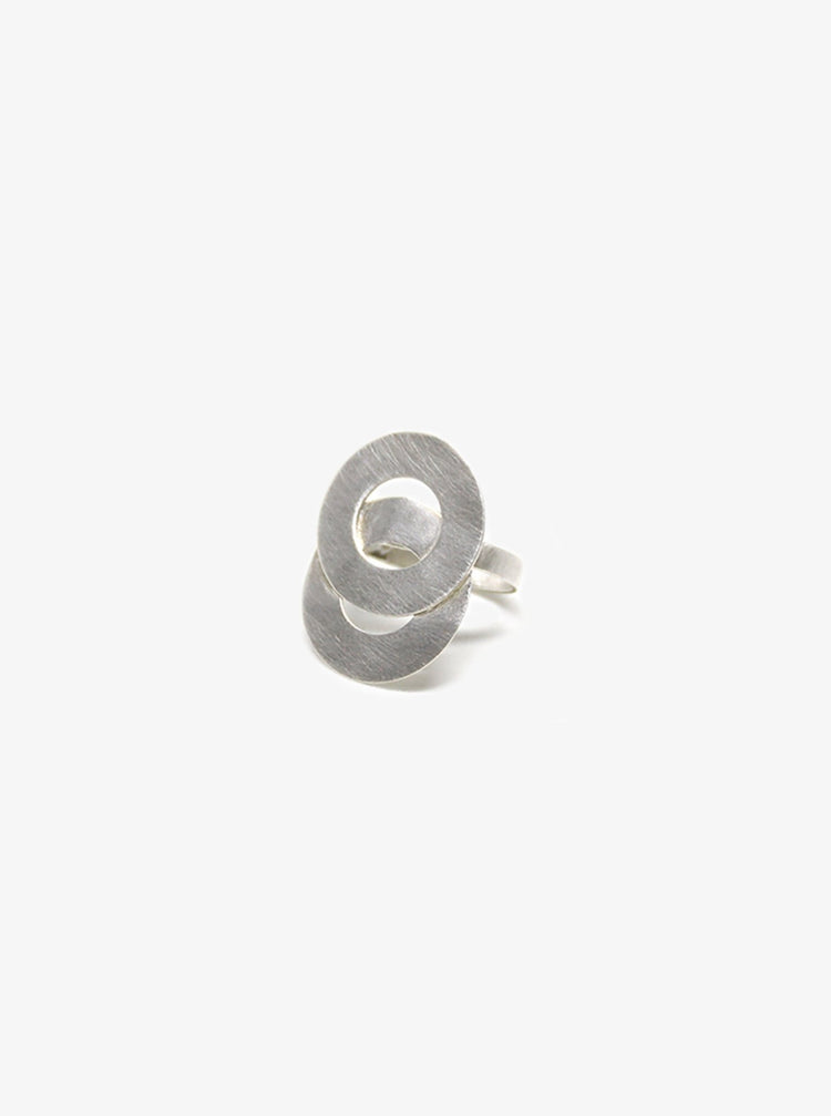 Silver ring two interlaced infinity symbol circles. Statement jewelry handcrafted in Brooklyn New York by designer llayers.