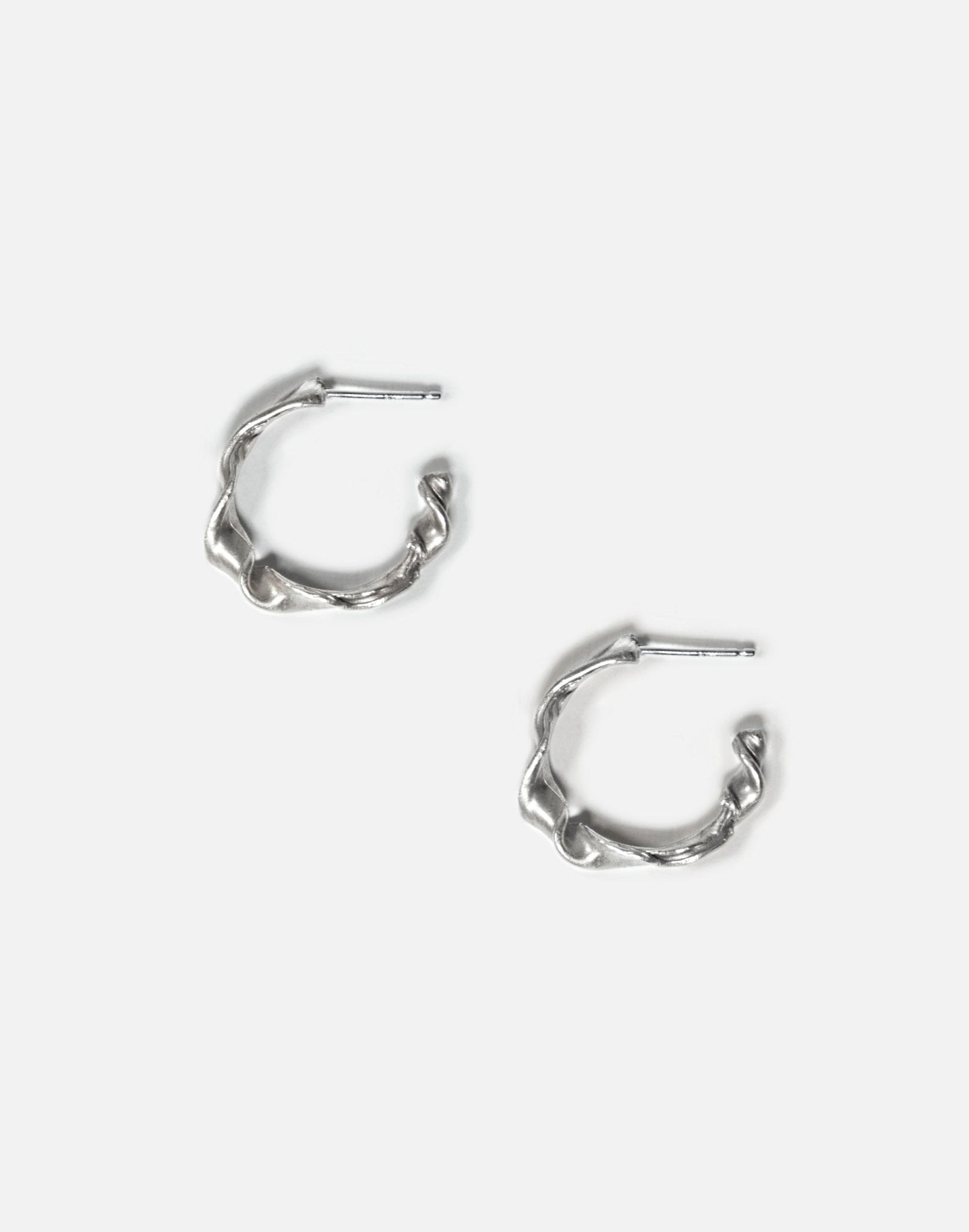 Sterling silver twisted hoop earrings essence. Minimalist jewelry made in Brooklyn New York by llayers.