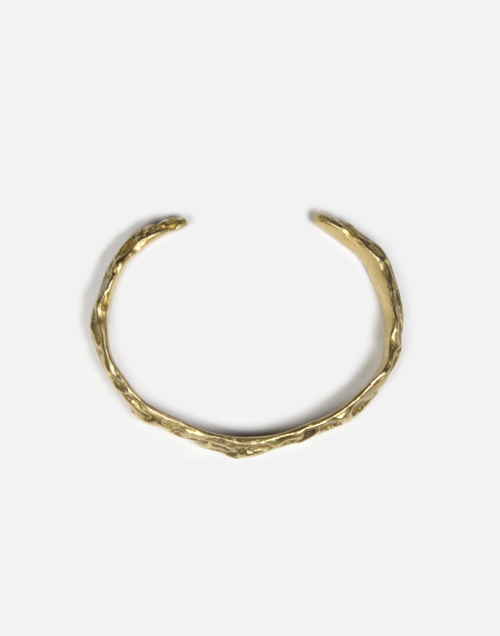 minimalist gold brass sculptural molten cuff bracelet in New York