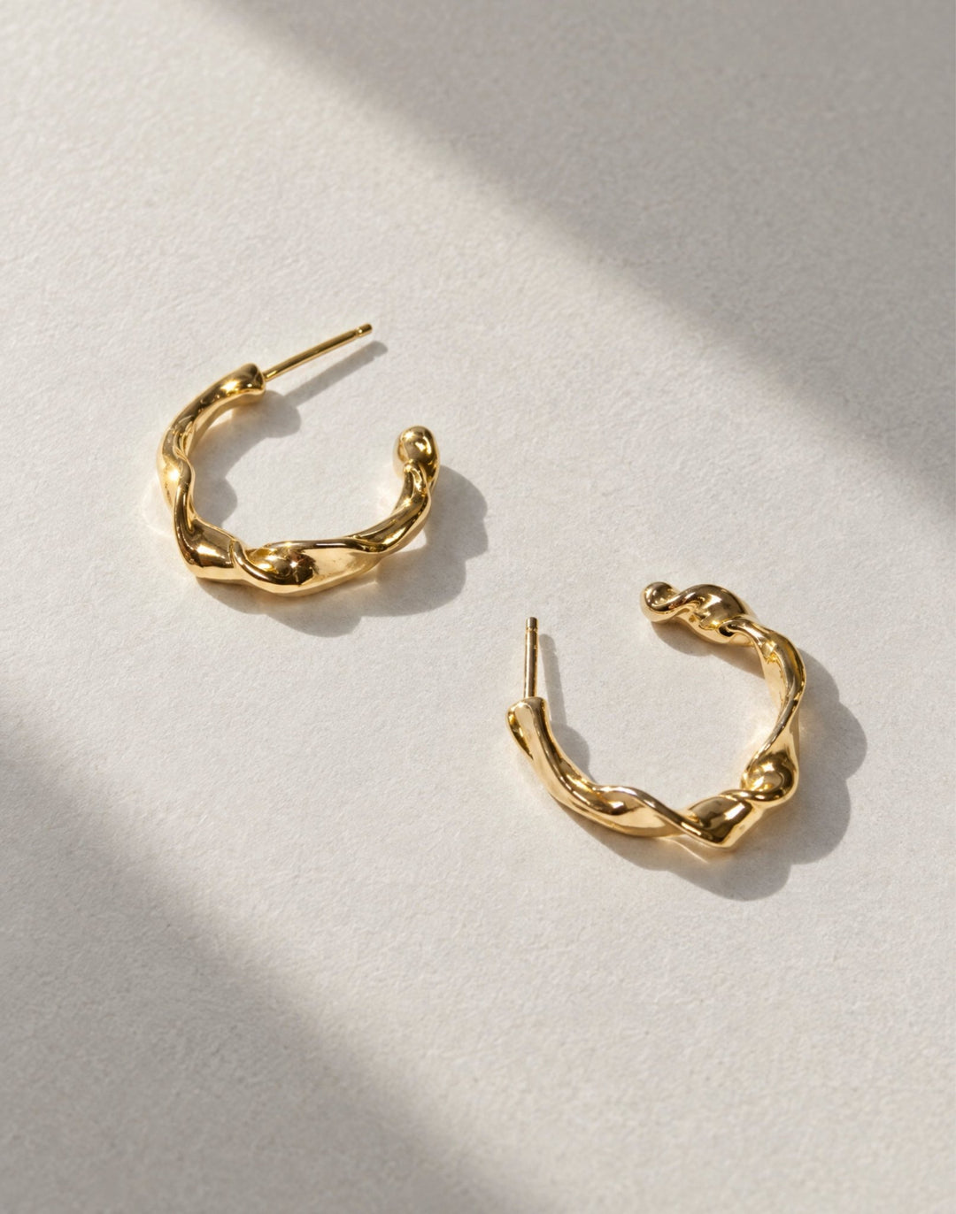 Gold twisted hoop earrings essence. Minimalist jewelry made in Brooklyn New York by llayers.