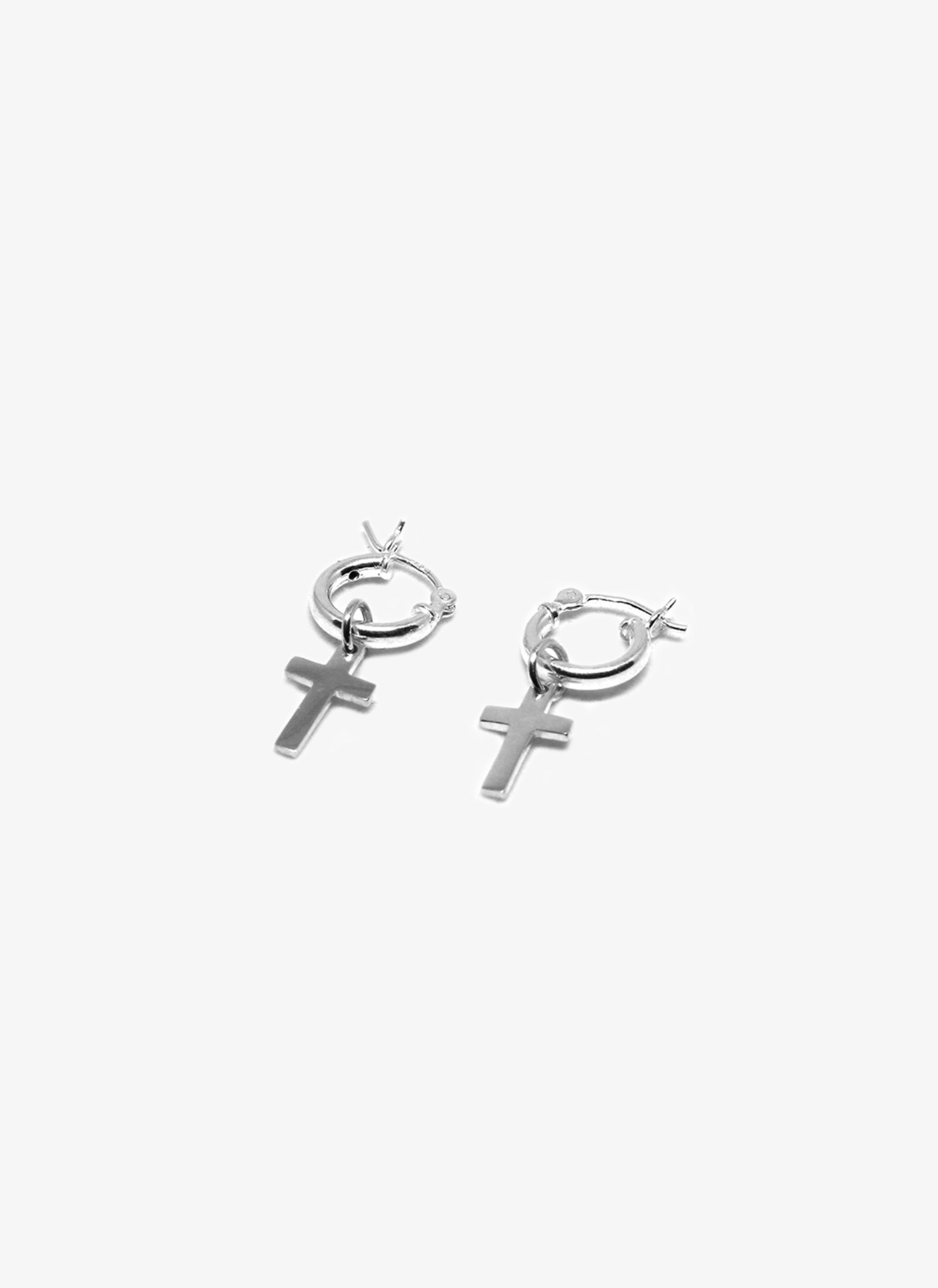 Silver cross earrings on a white background