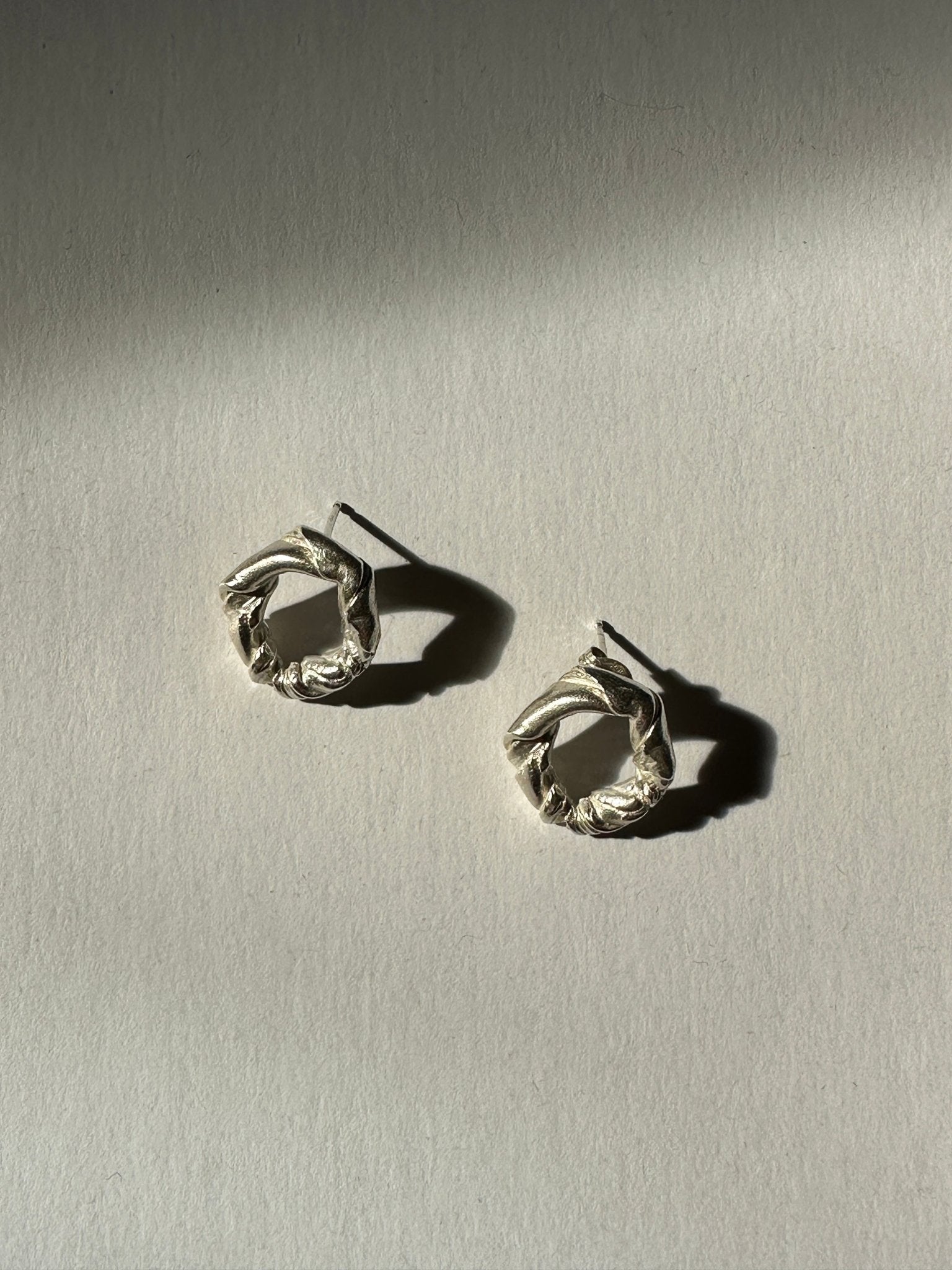 Men women Sterling silver twisted stud earrings. Jewelry made in Brooklyn New York by designer llayers.